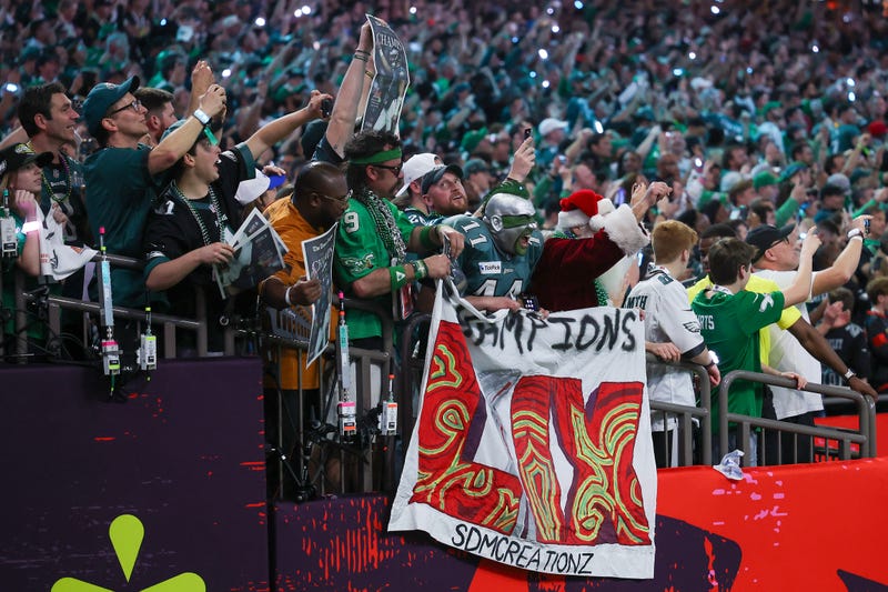 Eagles fans unfurl a Super Bowl champions banner after victory in the Caesar's Superdome in Super Bowl LIX.