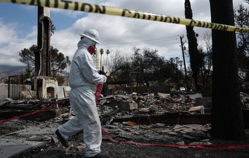 ALTADENA, CALIFORNIA - FEBRUARY 11: An Environmental Protection Agency (EPA) contractor takes down protective tape while working to remove hazardous waste from homes destroyed in the Eaton Fire on February 11, 2025 in Altadena, California. The EPA is assigned to safely dispose of hazardous materials from properties which burned in the Palisades Fire and Eaton Fire. The Federal Emergency Management Agency (FEMA) and the Army Corps of Engineers are slated to begin private property debris removal today from the Eaton And Palisades fires.