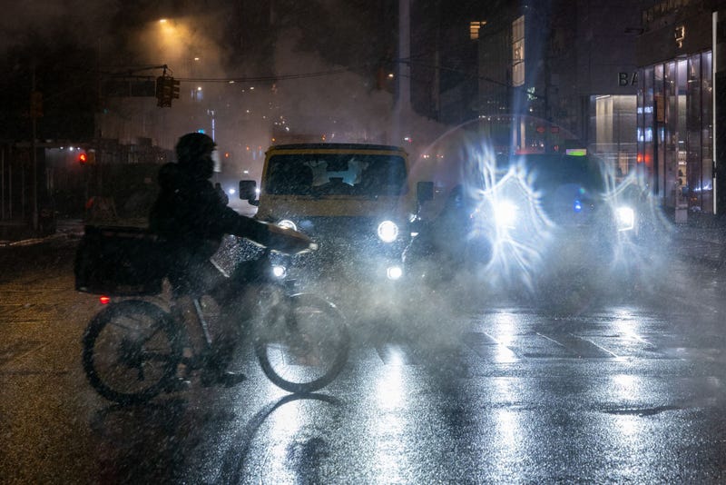 People move through Manhattan during an evening snow storm on Feb. 11, 2025 in New York City.