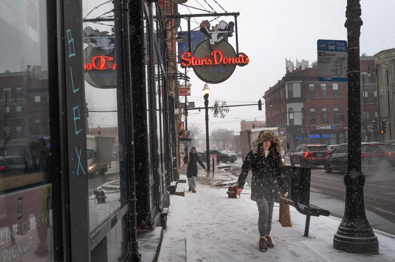 person walks as snow falls
