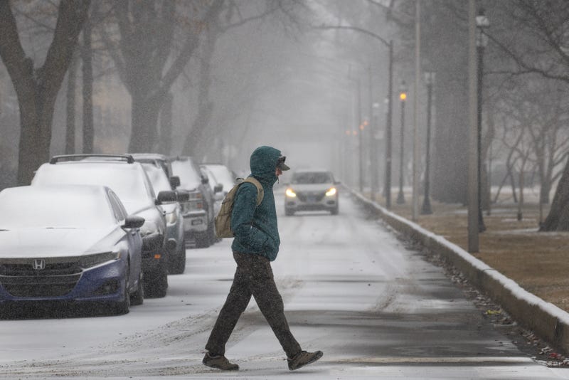 A person walks as snow falls on February 12, 2025 in Chicago, Illinois. The city is bracing for the first winter storm of the season, which is set to hit Sunday evening. 