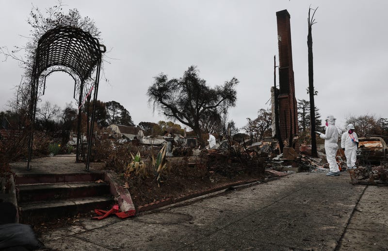 Environmental Protection Agency (EPA) contractors work to remove hazardous waste from a home destroyed in the Eaton Fire on February 12, 2025 in Altadena, California.