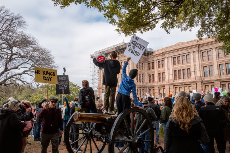 Children participate in a protest against U.S. President Donald Trump from atop a canon monument during the "Not My President's Day" demonstration at the Texas State Capitol on Feb. 17, 2025, in Austin, Texas.