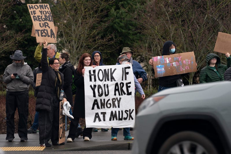 SEATTLE, WASHINGTON - FEBRUARY 22: Demonstrators gather for a protest against Elon Musk and electric car maker Tesla on February 22, 2025 in Seattle, Washington. Hundreds rallied at various entrances to the University Village shopping mall, in addition to the Tesla showroom's storefront at the mall. (Photo by David Ryder/Getty Images)