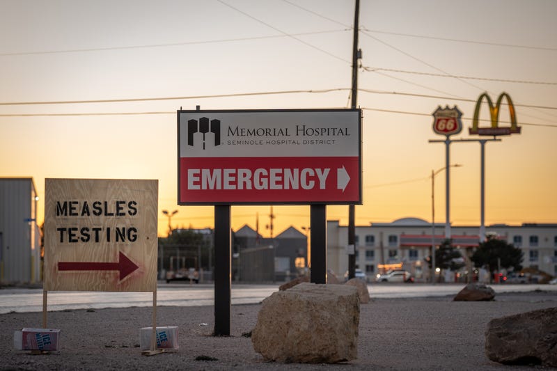 SEMINOLE, TEXAS - FEBRUARY 27: Signs point the way to measles testing in the parking lot of the Seminole Hospital District across from Wigwam Stadium on February 27, 2025 in Seminole, Texas. Eighty cases of measles have been reported in Gaines county with one death reported. (Photo by Jan Sonnenmair/Getty Images)