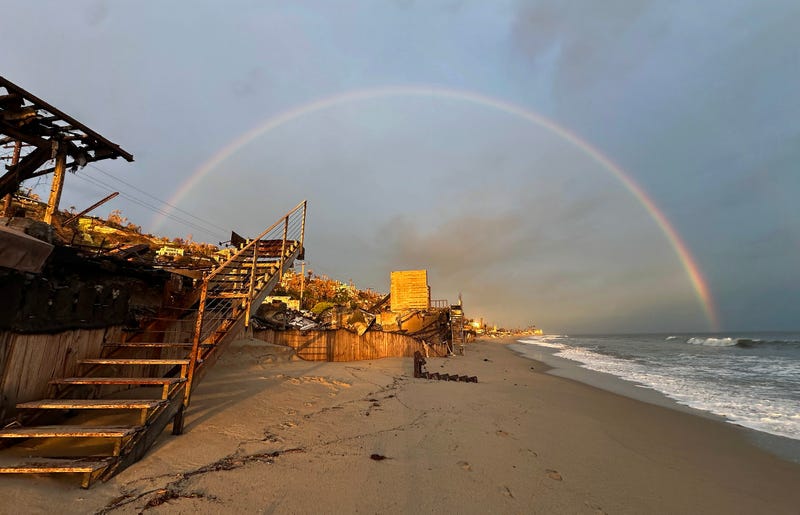 A rainbow appears over beachfront properties destroyed in the Palisades Fire along the Pacific Ocean on March 06, 2025 in Malibu, California.