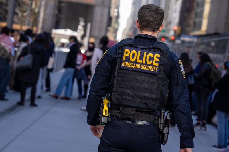 A Department of Homeland Security officer stands guard at 26 Federal Plaza as protesters gather to demand the release of Mahmoud Khalil at Foley Square on March 10, 2025