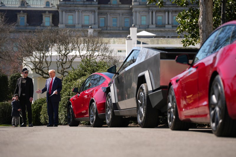 President Donald Trump, joined by White House Senior Advisor, Tesla and SpaceX CEO Elon Musk and his son X Æ A-Xii, delivers remarks next to a Tesla Model Y, a Cyber Truck and a Model S on the South Lawn of the White House on March 11, 2025
