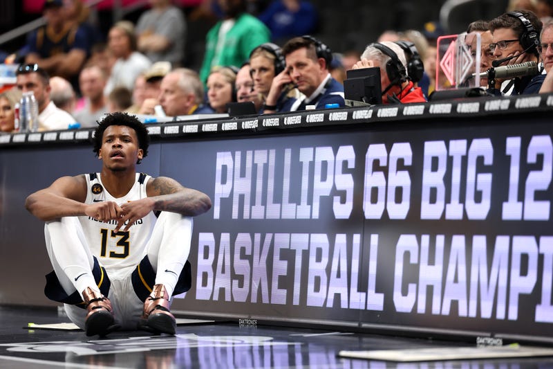 Amani Hansberry #13 of the West Virginia Mountaineers waits to substitute into the game and watches as the Colorado Buffaloes defeat the Mountaineers 67-60 to win the second round game of the Big 12 men's basketball tournament at T-Mobile Center on March 11, 2025 in Kansas City, Missouri.