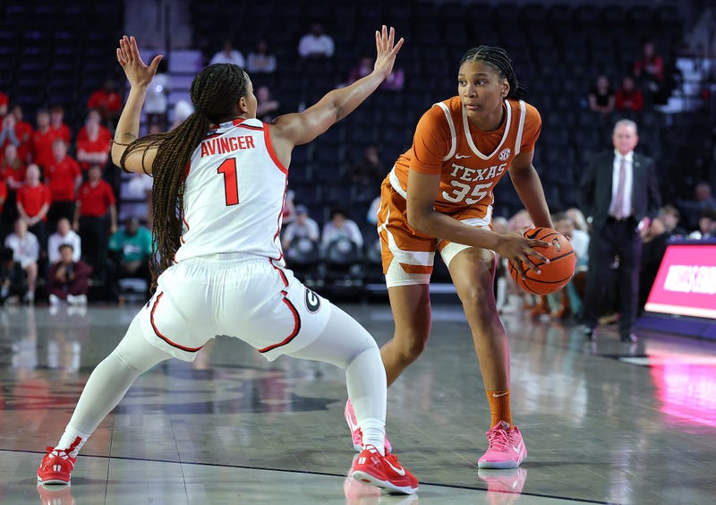 Madison Booker #35 of the Texas Longhorns is defended by Asia Avinger #1 of the Georgia Lady Bulldogs during the first quarter at Stegeman Coliseum on Feb. 24, 2025, in Athens, Georgia.