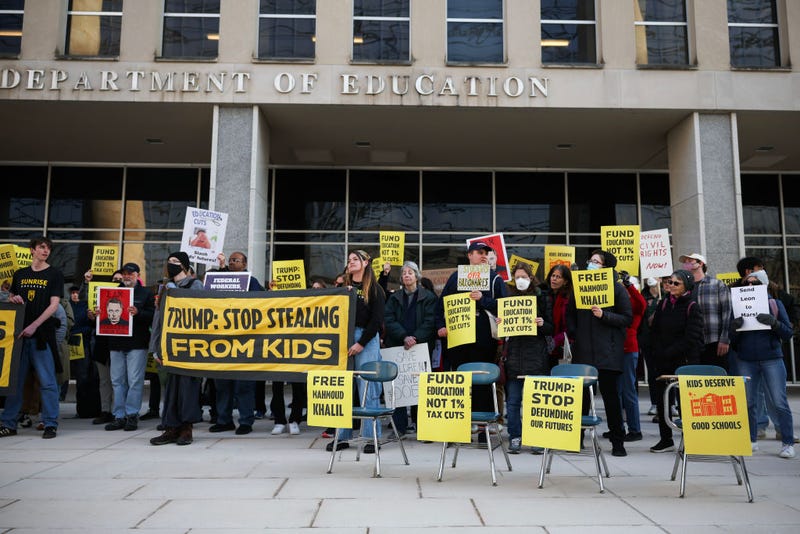 Community members rally in front of the Department of Education with school desks to protest budget cuts on March 13, 2025 in Washington, DC.  