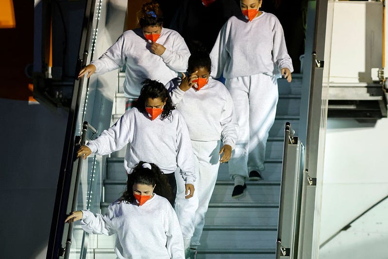 Venezuelan migrants deported from the United States walk down a plane upon arrival at Simon Bolivar International Airport in Maiquetia, Venezuela on March 28, 2025