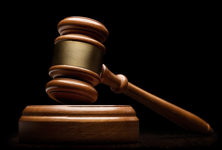 Close-up view of wooden gavel on black background