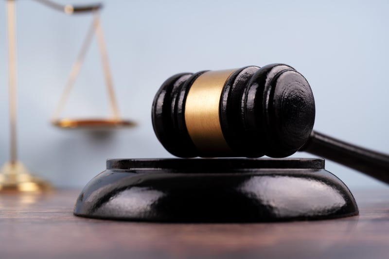 Close up of a gavel set with background of blurred image scales of justice