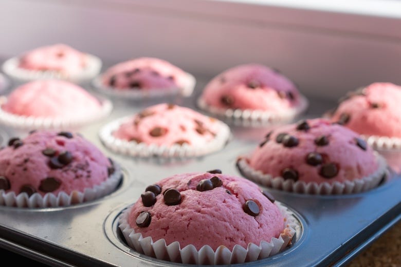 Tray of pink muffins with chocolate chips