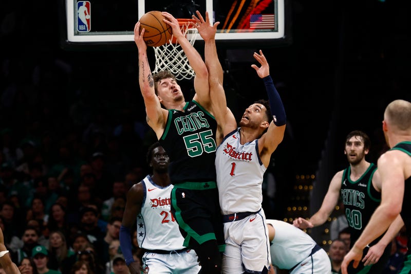 Baylor Scheierman #55 of the Boston Celtics grabs a loose ball from Colby Jones #1 of the Washington Wizards during the second half at TD Garden on April 6, 2025 in Boston, Massachusetts.