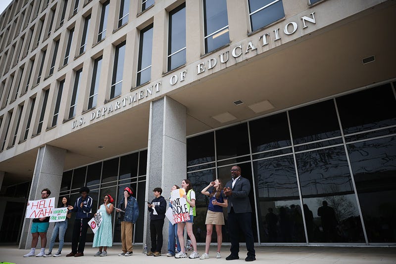 Student protestors hold signs while participating in the "Hands Off Our Schools" rally in front of the U.S. Department of Education on April 04, 2025 in Washington, DC. 