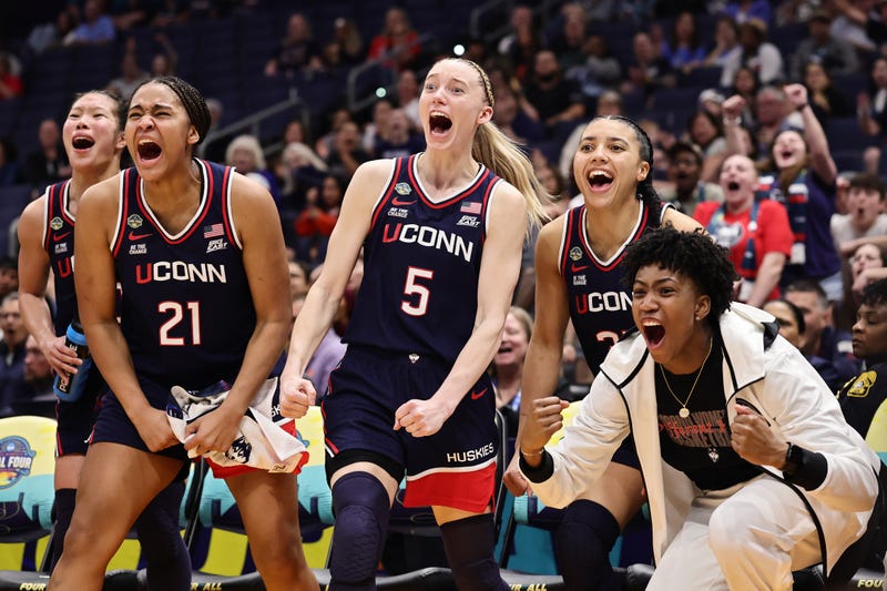 UConn's Sarah Strong, Paige Bueckers and Azzi Fudd celebrate from the bench during a Final Four rout of UCLA, 4/4/25