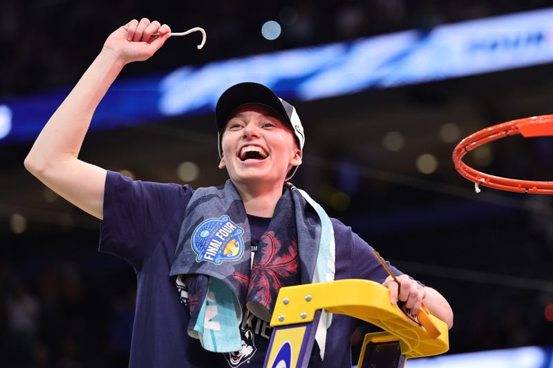 TAMPA, FLORIDA - APRIL 06: Paige Bueckers #5 of the UConn Huskies celebrates with a piece of the net after beating the South Carolina Gamecocks 82-59 to win the National Championship of the NCAA Women's Basketball Tournament at Amalie Arena on April 06, 2025 in Tampa, Florida. (Photo by Carmen Mandato/Getty Images)