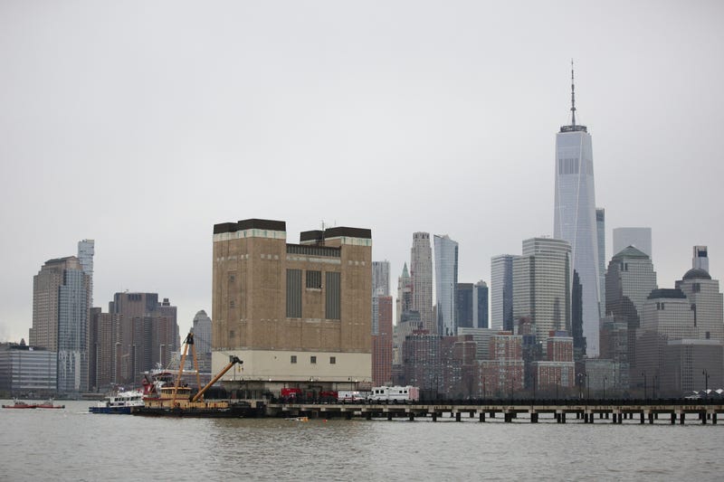 First responders are seen near the landing skids of a helicopter (C, in water) after it crashed into the Hudson River, in the Newport neighborhood of Jersey City, New Jersey, on April 10, 2025.