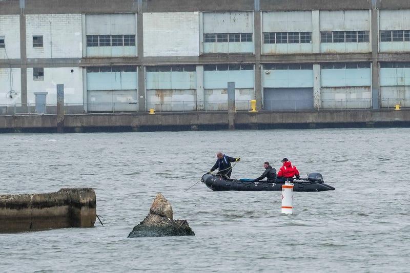 NYPD scuba divers team search next to the site of a crashed helicopter on the Hudson River on April 11, 2025 in Jersey City