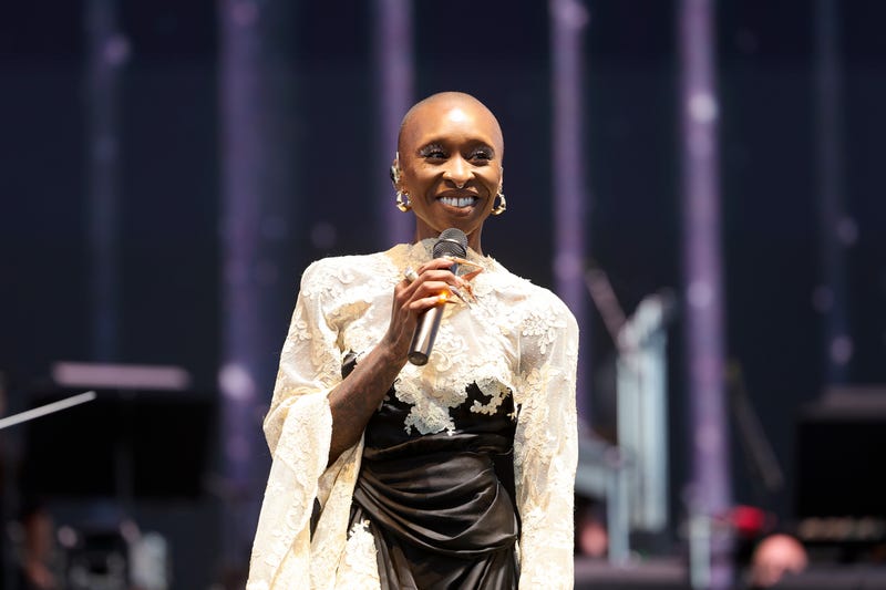 Cynthia Erivo holding a microphone and smilling