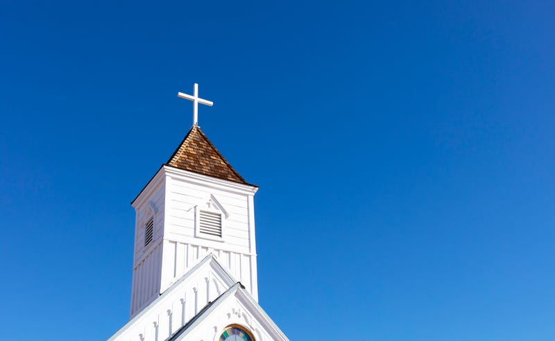 Wood cross on old church steeple