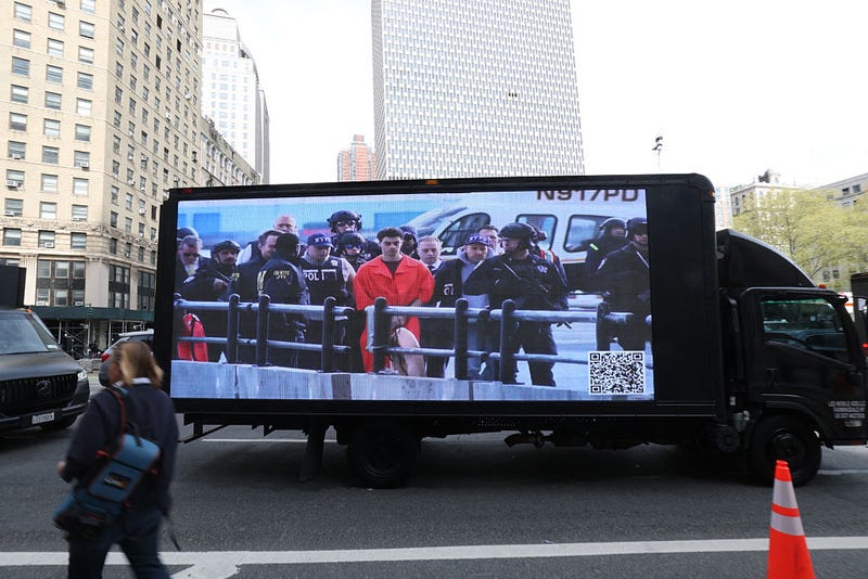 A truck with a video screen outside Manhattan Federal Court on April 25, 2025 to attend court as Luigi Mangione is set to be arraigned in New York federal court on a four-count indictment for the murder of United Healthcare CEO Brian Thompson.