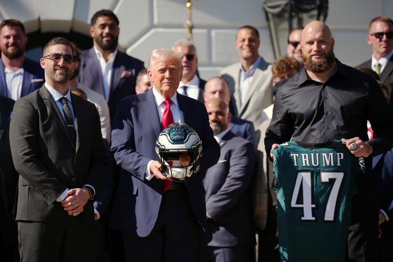 President Donald Trump holds a helmet as he poses with Philadelphia Eagles head coach Nick Sirianni and offensive tackle Lane Johnson at an event welcoming the 2025 Super Bowl Champion Philadelphia Eagles on the South Lawn of the White House on April 28, 2025 in Washington, DC.