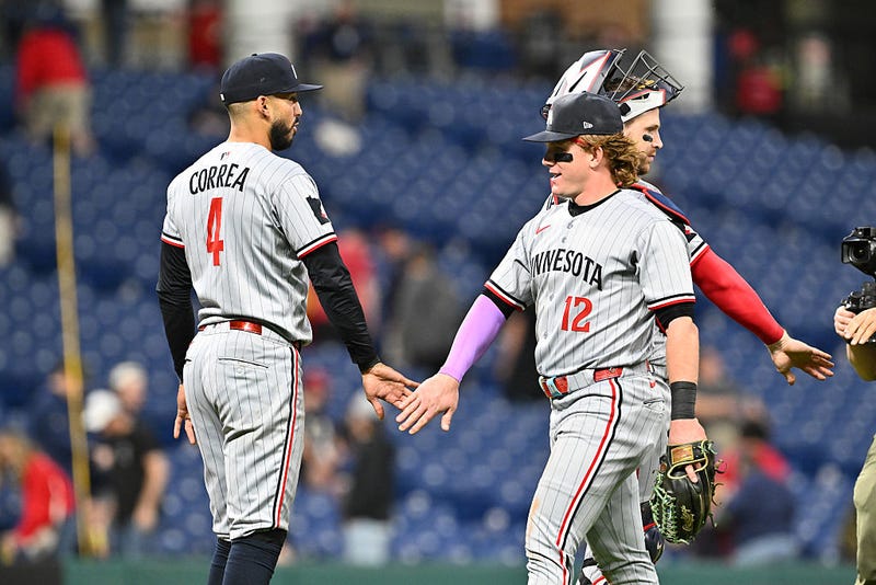 Carlos Correa #4 of the Minnesota Twins celebrates with teammate Harrison Bader #12 after the game against the Cleveland Guardians at Progressive Field on April 28, 2025 in Cleveland, Ohio. The Twins defeated the Guardians 11-1.