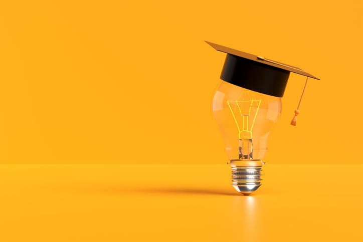 Light bulb wearing a graduation cap illuminates a yellow background, representing the power of education and innovative ideas