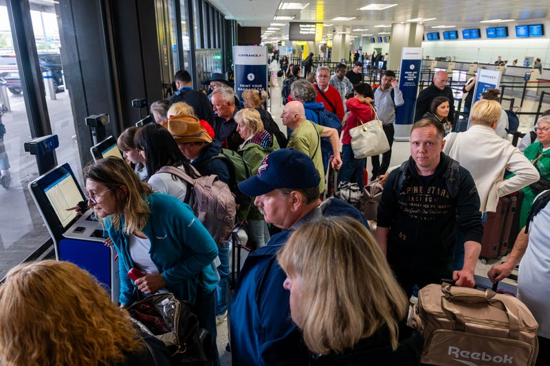 People wait in line for a delayed flight at Newark Liberty International Airport on May 5, 2025, in Newark, New Jersey.