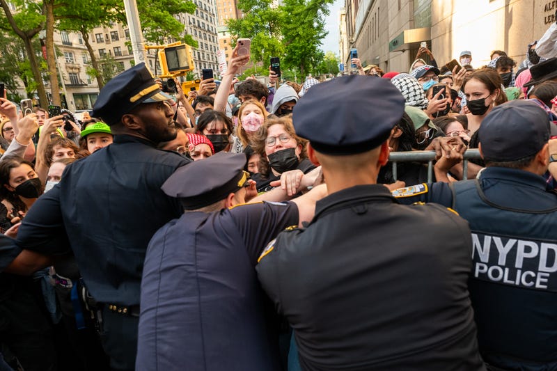 Police push back protesters as they gather outside of Columbia University's Butler Library after protesters occupied the space on May 7, 2025