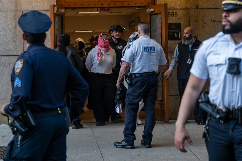Pro-Palestinian protesters are escorted out of Columbia University's Butler Library after their arrest for occupying the library space on May 7, 2025