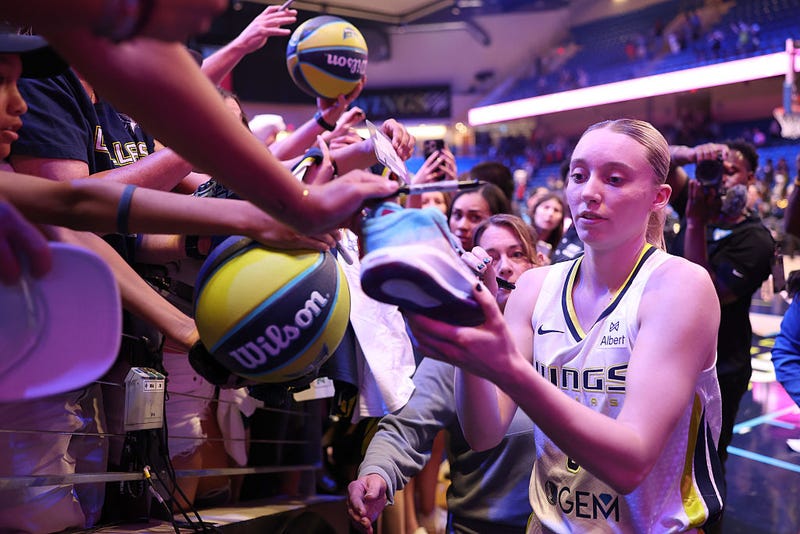 Paige Bueckers #5 of the Dallas Wings signs autographs after the preseason game against the Toyota Antelopes at College Park Center on May 10, 2025 in Arlington, Texas.