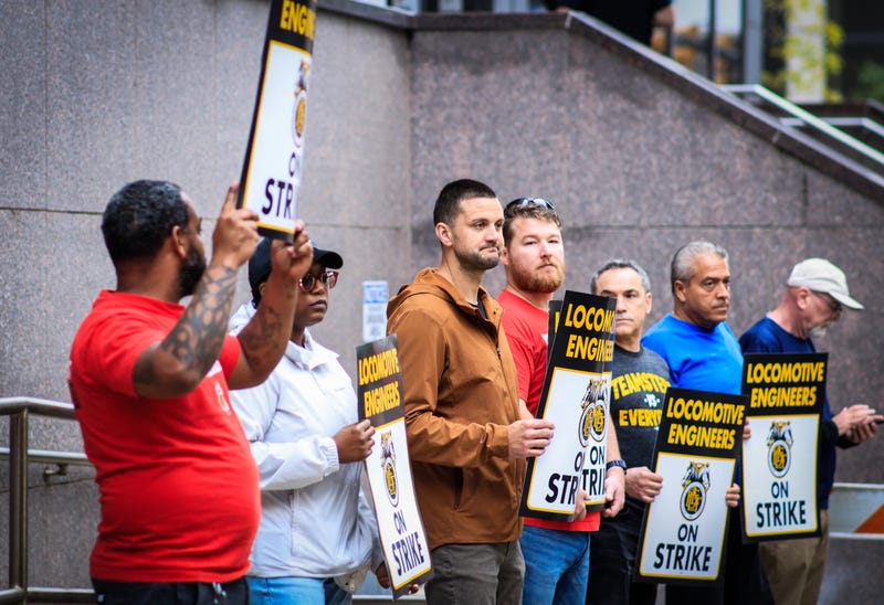 Members of the Brotherhood of Locomotive Engineers and Trainmen BLET Union Hold posters as they take part during a Strike outside NJ Transit's Headquarters on May 16, 2025 in Newark