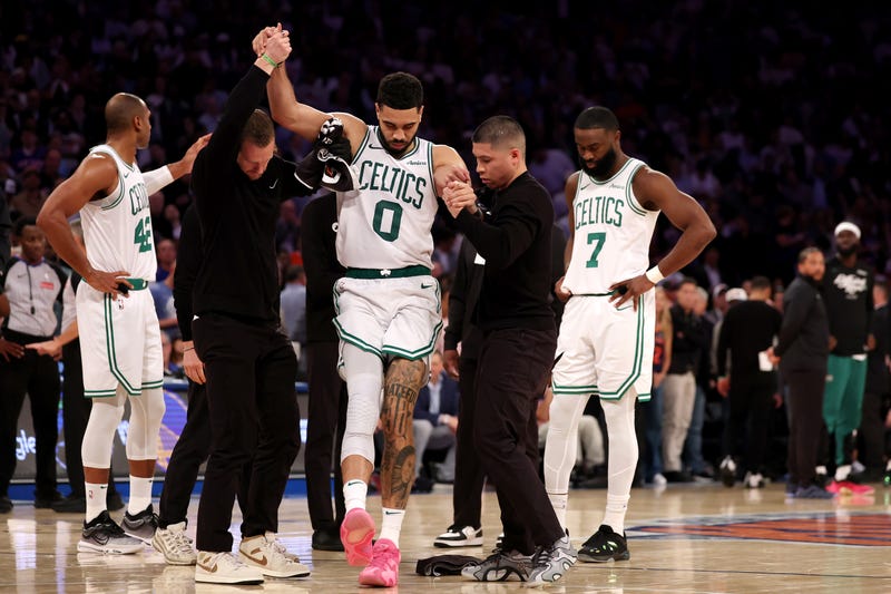 Jayson Tatum #0 of the Boston Celtics is assisted off court after being injured against the New York Knicks during the fourth quarter in Game Four of the Eastern Conference Second Round NBA Playoffs at Madison Square Garden on May 12, 2025 in New York City.