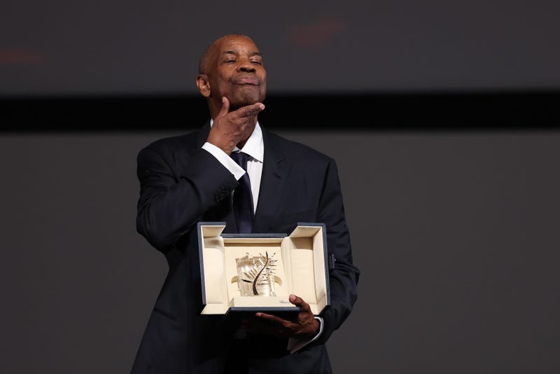 CANNES, FRANCE - MAY 19: Denzel Washington poses after receiveing an honorary Palme d'Or following a screening for the "Highest 2 Lowest" at the 78th annual Cannes Film Festival at Palais des Festivals on May 19, 2025 in Cannes, France. (Photo by Sameer Al-Doumy/Pool/Getty Images)