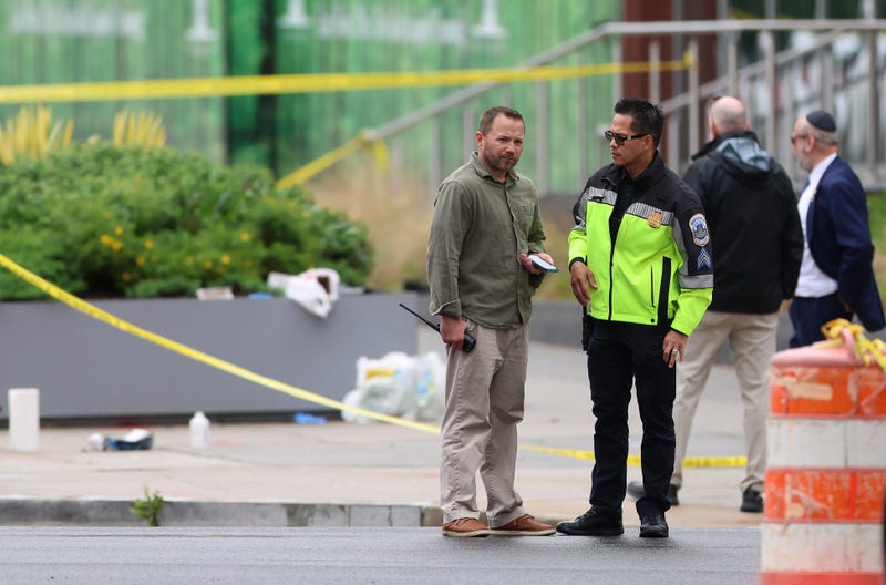 Law enforcement officers stand by near the shooting site outside the Lillian and Albert Small Capital Jewish Museum on May 22, 2025 in Washington, DC