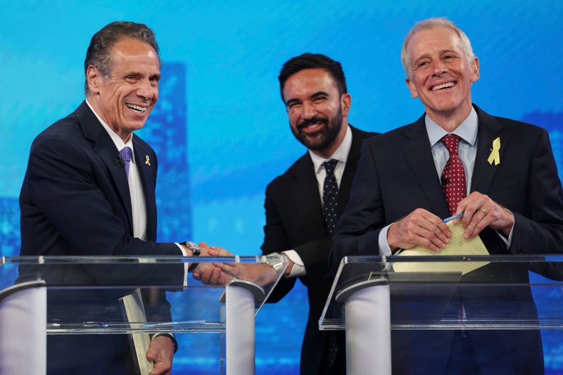 Democratic mayoral candidates Andrew Cuomo, left, shakes hands with Zohran Mamdani, center, as Whitney Tilson reacts after participating in the New York City Democratic Mayoral Primary Debate at NBC Studios on June 4, 2025