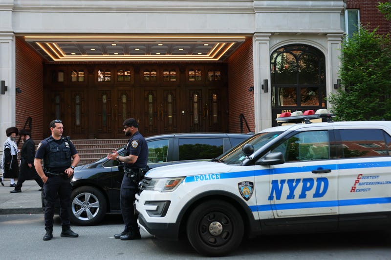 aNYPD officers stand guard outside a synagogue in Borough Park on June 2, 2025