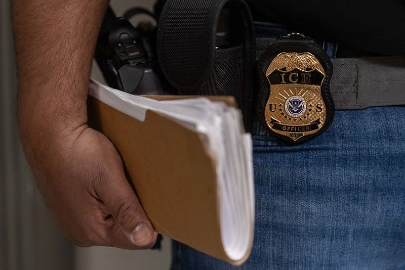 An Immigration and Customs Enforcement (ICE) agent stands outside of immigration court hearings