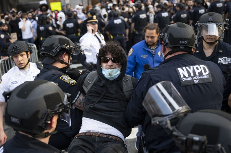 NYPD officers arrest a demonstrator during an anti-ICE protest outside 26 Federal Plaza Building on June 10, 2025