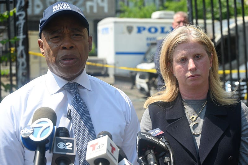 Mayor Eric Adams and NYPD Commissioner Jessica Tisch deliver a statement to the media at the parking lot where 11 NYPD vehicles were set on fire, blocks away from the 83rd Precinct in Bushwick, Brooklyn, in an arson attac