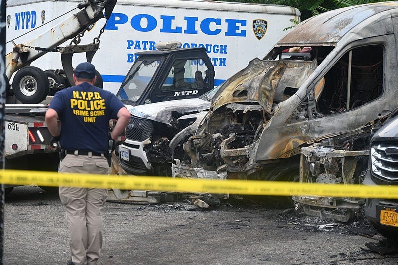 Police investigate following the arson of nearly a dozen NYPD vehicles in Bushwick, Brooklyn, on June 12