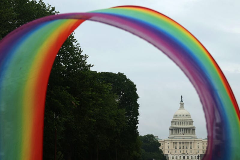rainbow banner in front of capital building