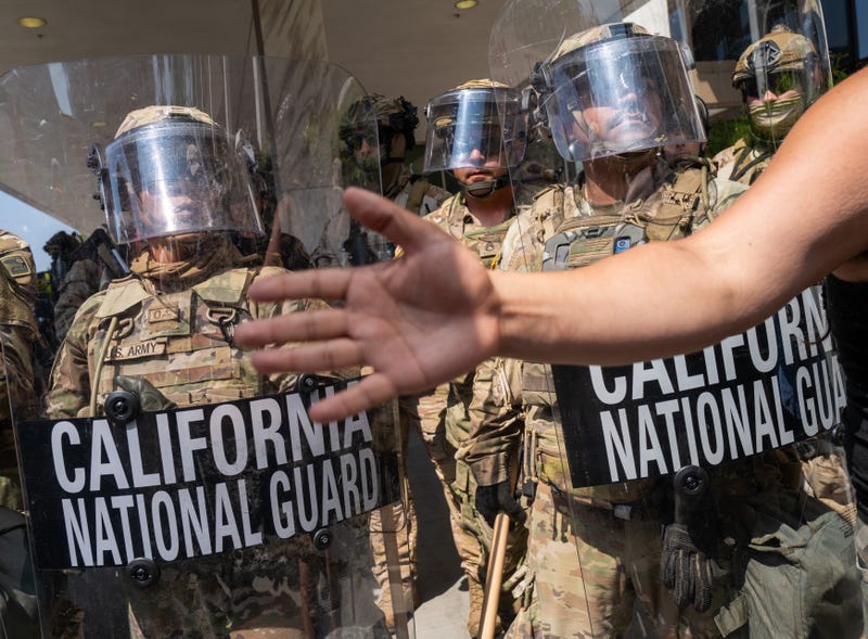 Protesters confront National Guard soldiers and police outside of a federal building as protests continue in Los Angeles following three days of clashes with police after a series of immigration raids on June 09, 2025, in Los Angeles, California. 