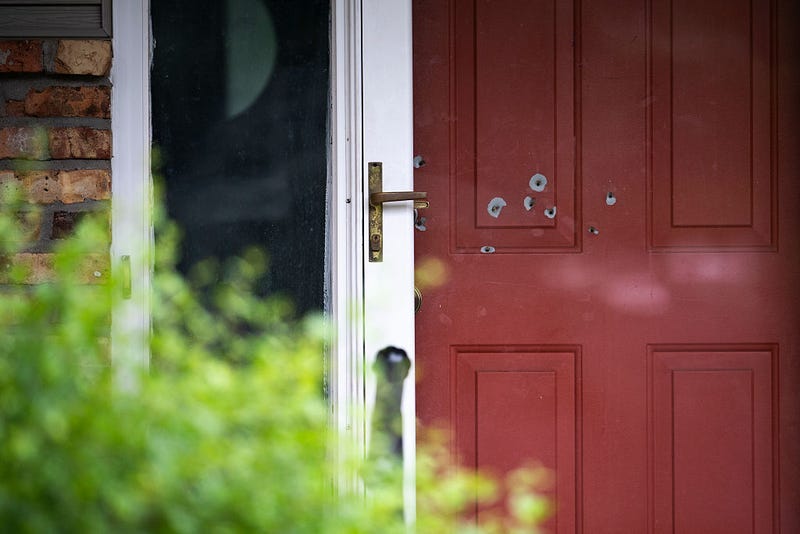 Bullet holes are seen in the door outside the home of DFL State Sen. John Hoffman on June 15, 2025 in Champlin, Minnesota. 