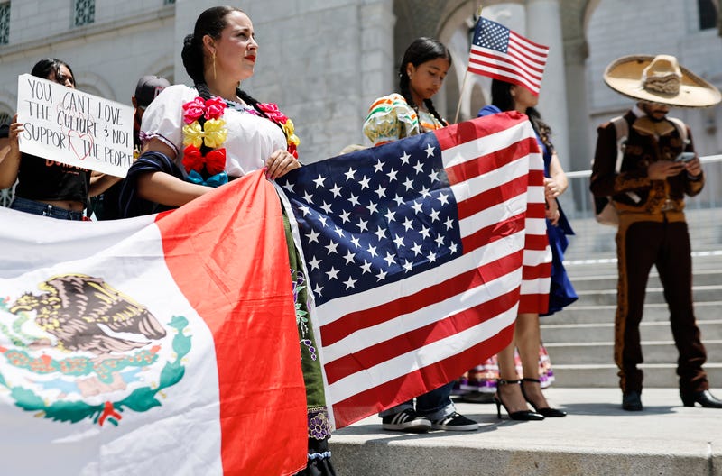 people with mexican and us flags