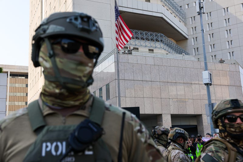  Federal agents guard outside of a federal building and Immigration and Customs Enforcement (ICE) detention center in downtown Los Angeles as demonstrations continue after a series of immigration raids began last Friday on June 13, 2025, in Los Angeles, California. 